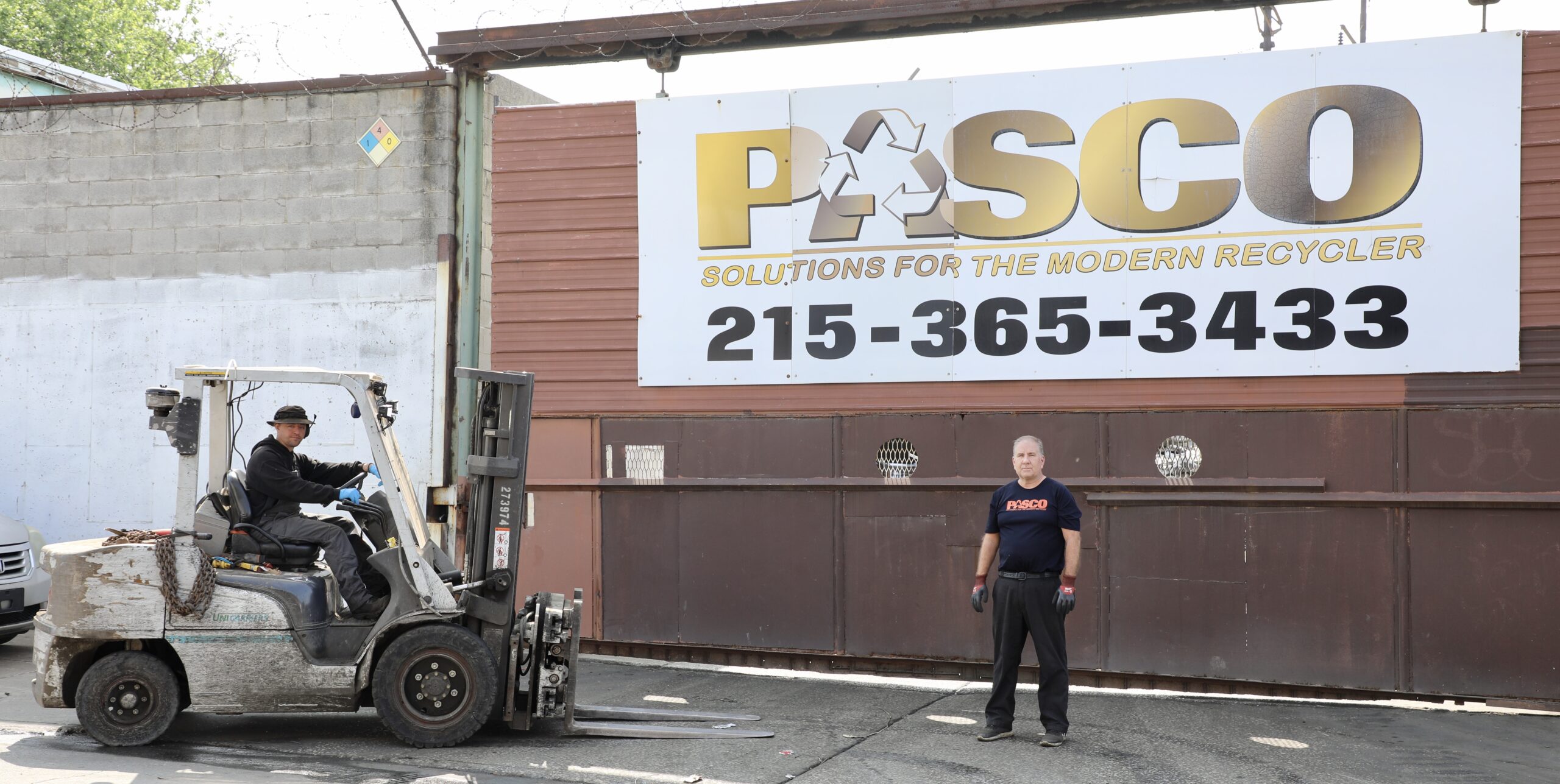 Pasco Owner standing in front of Pasco Signage